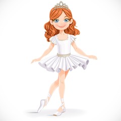 Beautiful little brunette ballerina girl in tiara stand on a whi