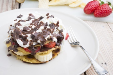 pancakes with strawberries, banana, blueberries and chocolate...