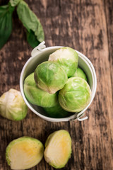 Fresh brussel sprouts over rustic wooden texture.healthy food