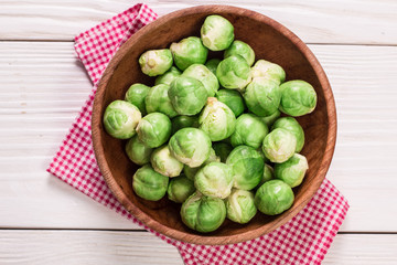 Fresh brussel sprouts over rustic wooden texture.healthy food