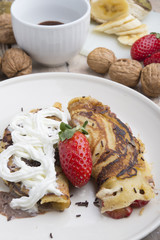 delicious crepes with berries and chocolate sauce, closeup