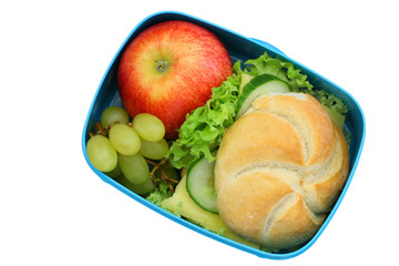 Lunch box containing bread roll with cheese, lettuce and cucumber, red apple isolated on white
