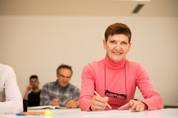 Naklejka premium Group of people of different age sitting in classroom and attend