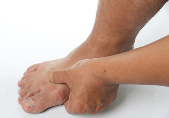 Man hands are squeezing the feet to wake apply pain from his injuries on white background.