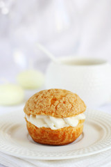 profiterole stuffed with cream on a white background