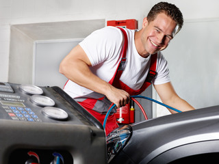 Car mechanic checks the air handling unit of a car 