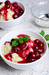 Rice Pudding with Cherry Sauce on white background