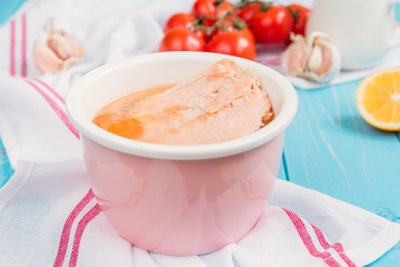 Salmon soup in pink bowl