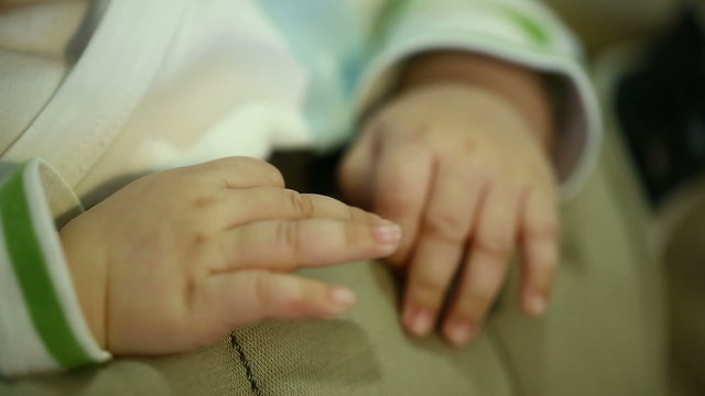 Newborn baby moving her fingers in a closeup view