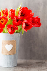 Red tulips on a wooden background.