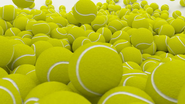 Animated realistic plain (without name, brand) yellow-light green 1000+  tennis balls falling-pouring and bouncing against white background.  With shallow depth of field.