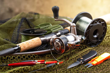 fishing tackle on a wooden table. toned image
