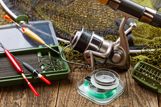 fishing tackle on a wooden table. toned image
