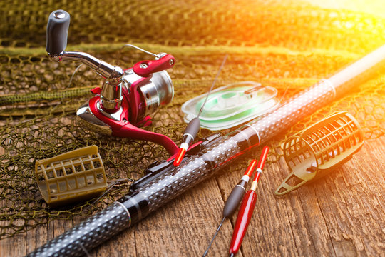 fishing tackle on a wooden table. toned image