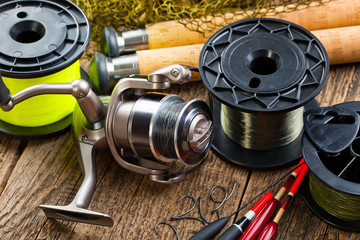 fishing tackle on a wooden table. toned image