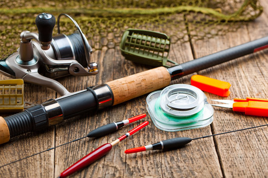 fishing tackle on a wooden table. toned image