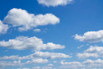 Naklejka na ściany i meble Cloudscape over horizon. White heap clouds in the blue sky. 