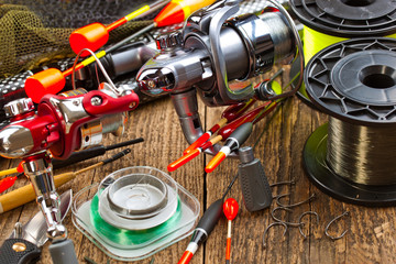 fishing tackle on a wooden table. toned image