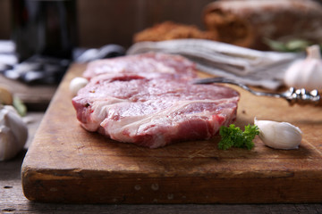 Marbled beef steak and spices on wooden background