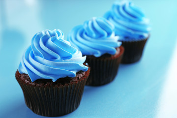 Chocolate cupcakes on blue background