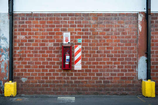 Extinguishers on a brick wall