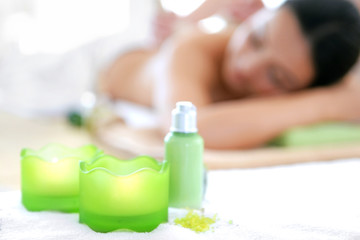 Obraz na płótnie Canvas Spa concept. Someone do relaxing massage with herbal balls to beautiful woman, unfocused