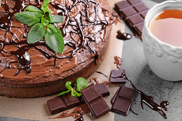 Decorated chocolate pie with tea cup, closeup