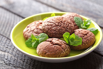 Chocolate chip cookie with yellow stripe and mint in plate, closeup