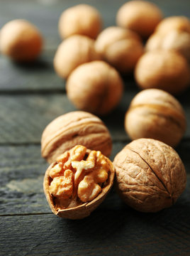 Walnuts on grey wooden table, close-up