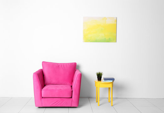 Living room interior with pink armchair and yellow chair on white wall background