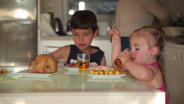 Children dine chicken with potatoes