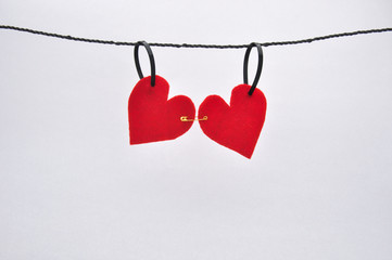 Red felt hearts pinned together on a line