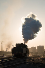 Fototapeta na wymiar Steam locomotive at sunset