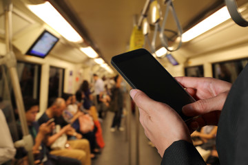 woman hand hold smart phone, cellphone  on blurred abstract city metro background as Daily Routine...