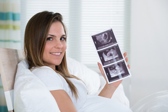 Young Woman Holding Ultrasound Photo
