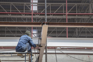 Naklejka na ściany i meble Unidentified steel workers on construction site
