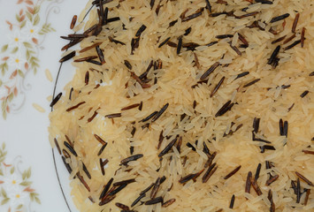 Uncooked long grain and wild rice on plate