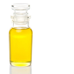 Olive oil in a glass bottle over white background