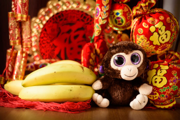 Fototapeta na wymiar Chinese new year decorations. Chinese year of the monkey. Monkey and bananas.