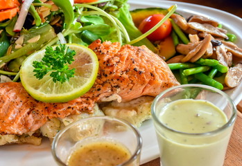Grilled salmon with salad and wasabi sauce