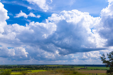 Summer landscape with green grass and clouds