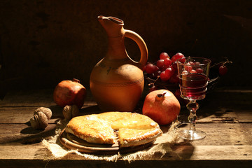 Red wine submitted with fruit, nuts and a cheese pie