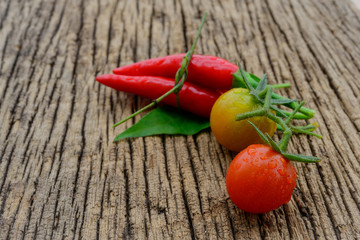 some chili peppers on a wood table