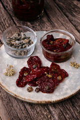 Delicious Sun Dried Tomatoes with Oregano and Capers. Traditional Italian food vegetables.