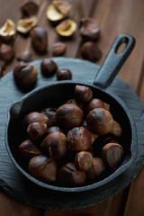 Close-up of roasted chestnuts in a frying pan, studio shot