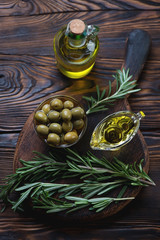Top view of extra virgin olive oil with fresh rosemary, close-up