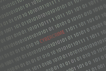 'Cybercrime' word in the middle of the computer screen surrounded by numbers zero and one. Image is taken in a small angle. Image has a vintage effect applied