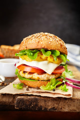 Healthy chicken hamburger, whole grain bun with fresh vegetables