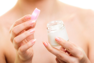 Skin care. Girl applying moisturizing cream.