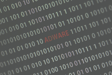'Adware' word in the middle of the computer screen surrounded by numbers zero and one. Image is taken in a small angle. Image has a vintage effect applied.